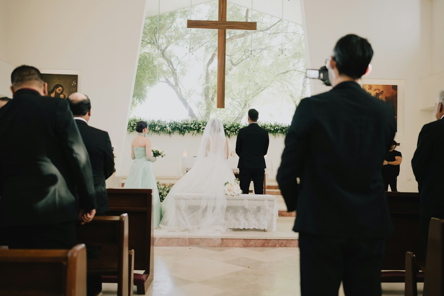 Bride and groom stand at the altar during a church ceremony.